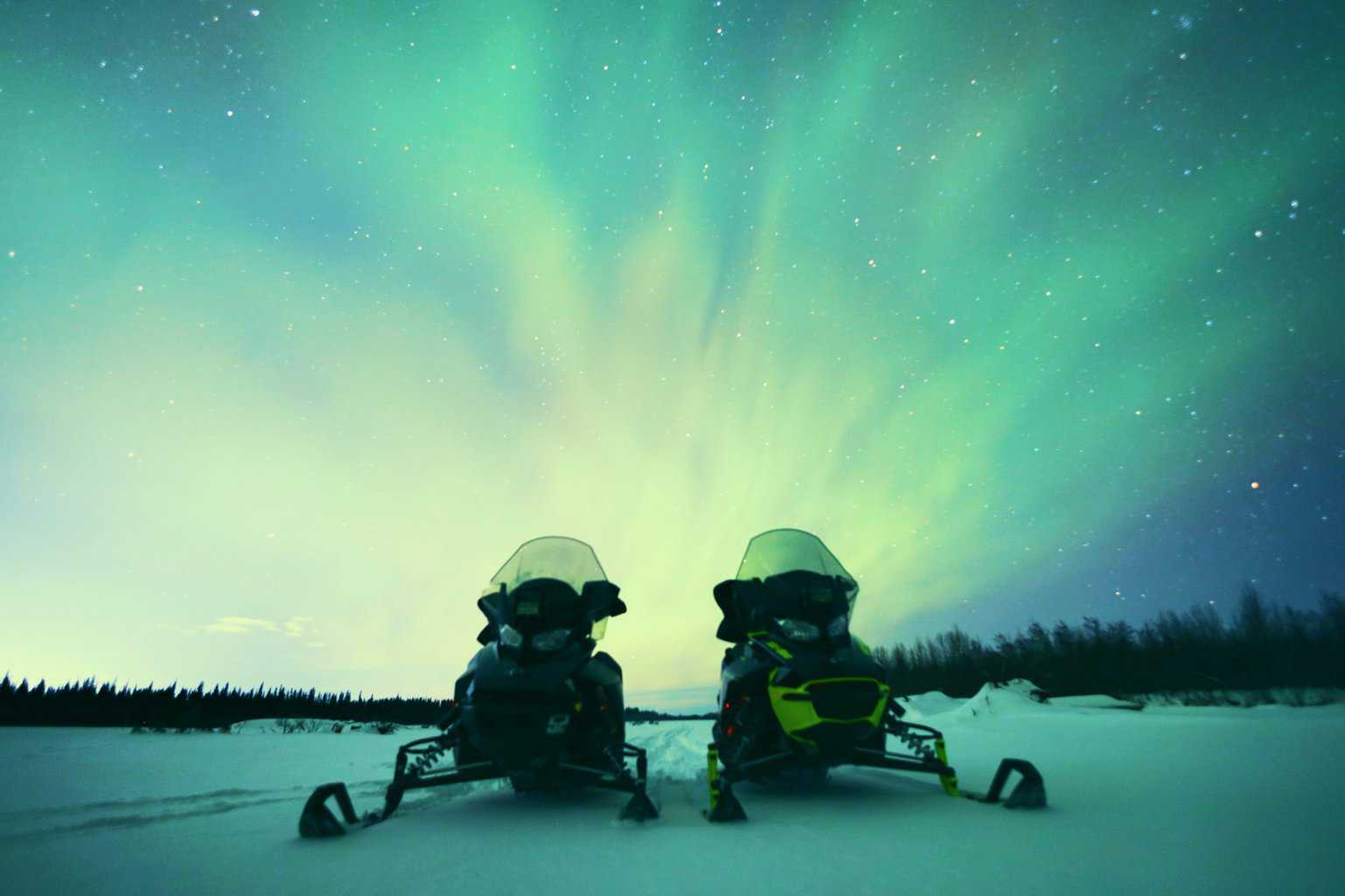snowmobiles waiting to be ridden
